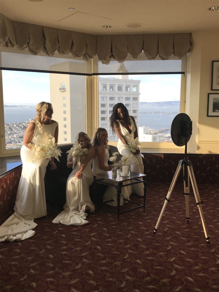4 brides pose for photobooth 