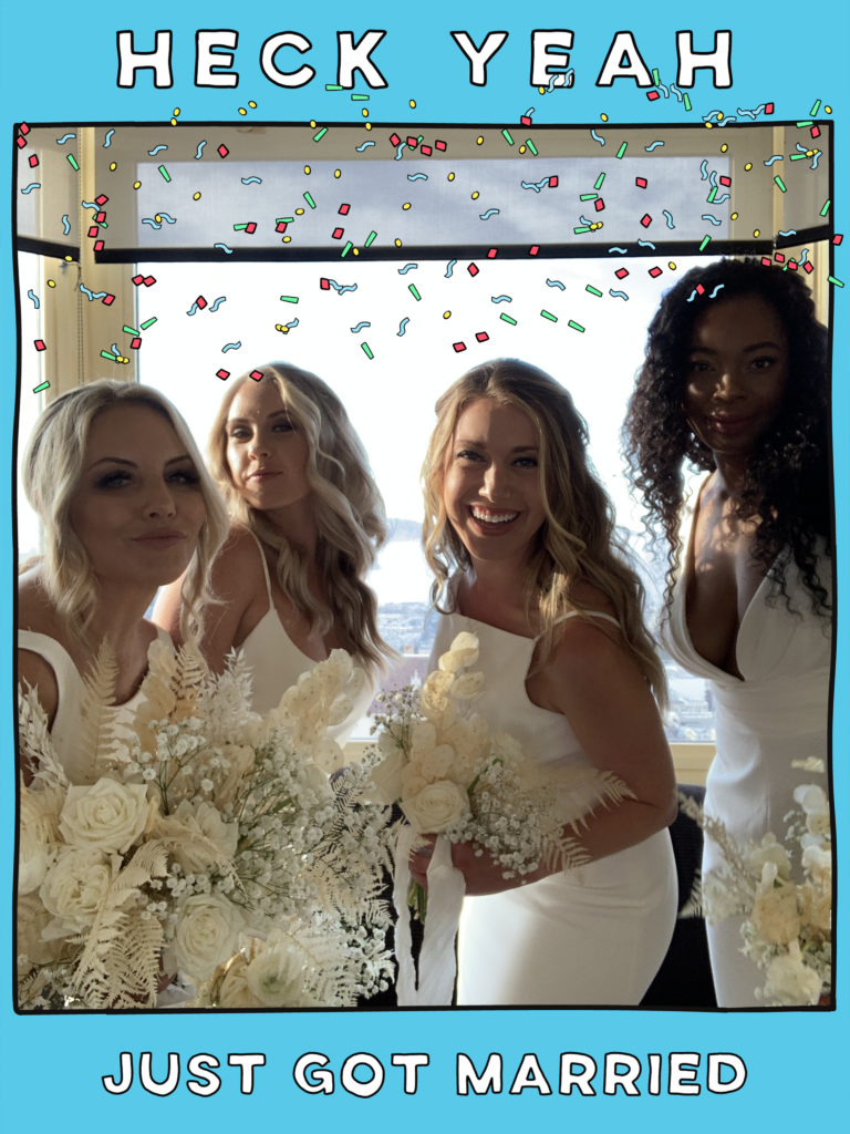 four brides pose for a photo booth with a blue frame that says heck yeah just got married 