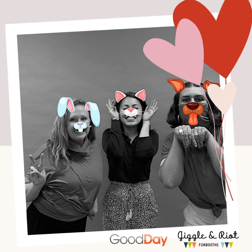 three women with virtual props pose in traveling photobooth