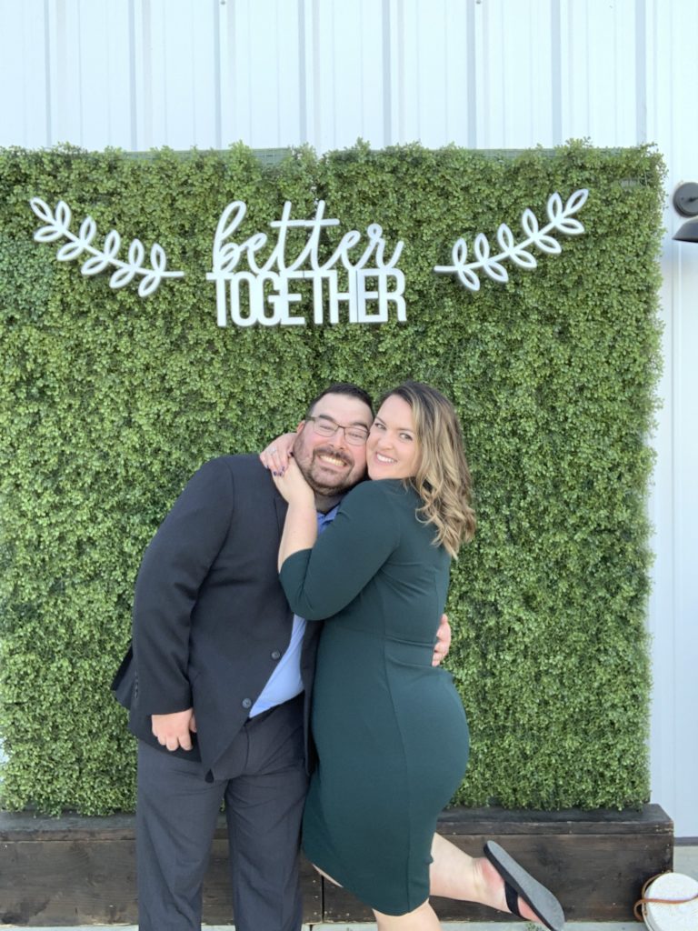 man and woman hug and pose for traveling photobooth