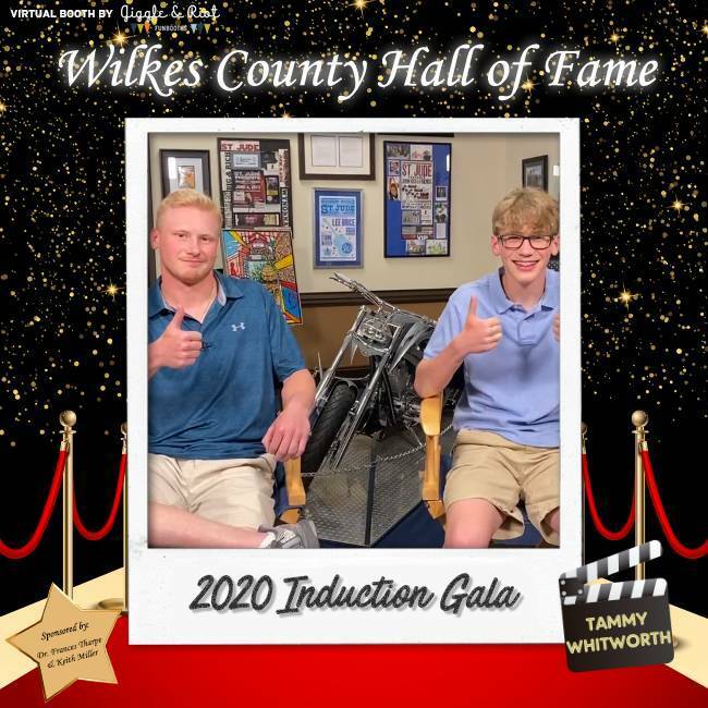two teens pose for virtual photobooth with hall of fame sticker